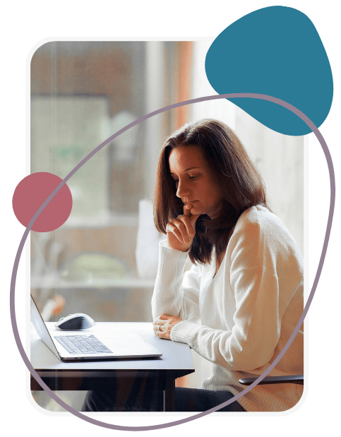 A woman sits at a desk, looking thoughtfully at a laptop screen. She rests her chin on her hand. Abstract shapes in blue and red are overlaid on the image.