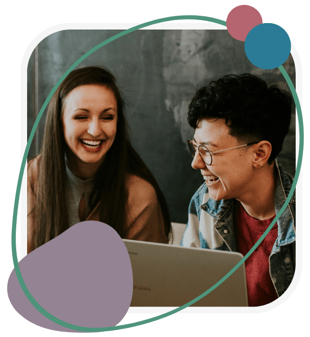 Two people laughing while looking at a laptop, conveying joy and connection. Background has abstract shapes adding a playful touch.